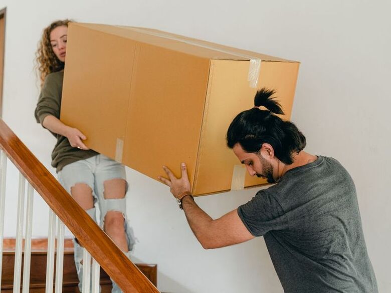 Marshian Movers crew carrying boxes into an Uptown Dallas high-rise